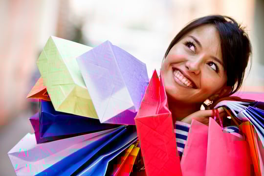 Happy shopping woman with bags and smiling